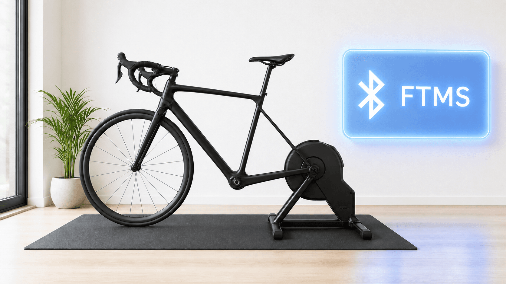 Black road bike on a smart trainer beside an illuminated Bluetooth FTMS panel