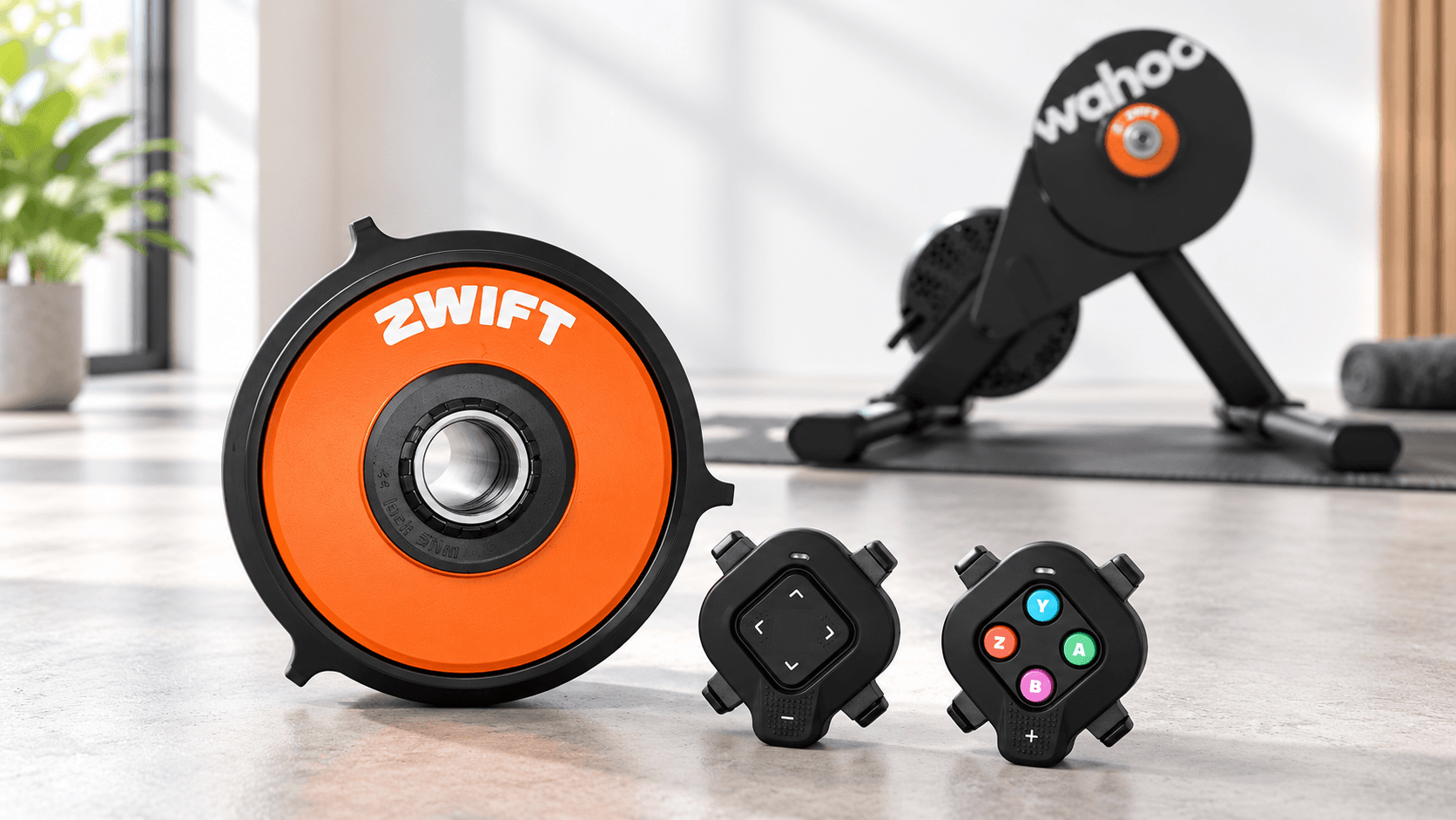 Orange Zwift Cog and two Click controllers with a Wahoo trainer behind them